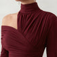 Woman wearing the Asymmetric Neck Open Back Midi Dress featuring an asymmetric mock-neck halter, off-shoulder ruched detailing, long fitted sleeves, an elegant open back, fitted midi silhouette and front slit, styled for weddings, cocktail parties and formal occasions.