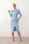 Woman wearing the Asymmetric Neck Open Back Midi Dress featuring an asymmetric mock-neck halter, off-shoulder ruched detailing, long fitted sleeves, an elegant open back, fitted midi silhouette and front slit, styled for weddings, cocktail parties and formal occasions.