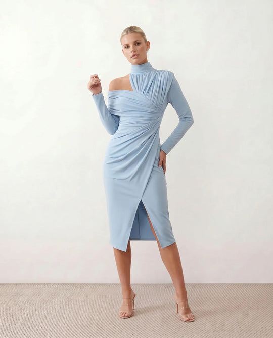 Woman wearing the Felisa Asymmetric Neck Open Back Midi Dress featuring an asymmetric mock-neck halter, off-shoulder ruched detailing, long fitted sleeves, an elegant open back, fitted midi silhouette and front slit, styled for weddings, cocktail parties and formal occasions.