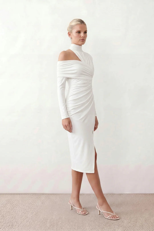 Woman wearing the Felisa Asymmetric Neck Open Back Midi Dress featuring an asymmetric mock-neck halter, off-shoulder ruched detailing, long fitted sleeves, an elegant open back, fitted midi silhouette and front slit, styled for weddings, cocktail parties and formal occasions.