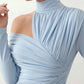 Woman wearing the Asymmetric Neck Open Back Midi Dress featuring an asymmetric mock-neck halter, off-shoulder ruched detailing, long fitted sleeves, an elegant open back, fitted midi silhouette and front slit, styled for weddings, cocktail parties and formal occasions.