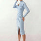 Woman wearing the Asymmetric Neck Open Back Midi Dress featuring an asymmetric mock-neck halter, off-shoulder ruched detailing, long fitted sleeves, an elegant open back, fitted midi silhouette and front slit, styled for weddings, cocktail parties and formal occasions.