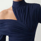 Woman wearing the Asymmetric Neck Open Back Midi Dress featuring an asymmetric mock-neck halter, off-shoulder ruched detailing, long fitted sleeves, an elegant open back, fitted midi silhouette and front slit, styled for weddings, cocktail parties and formal occasions.