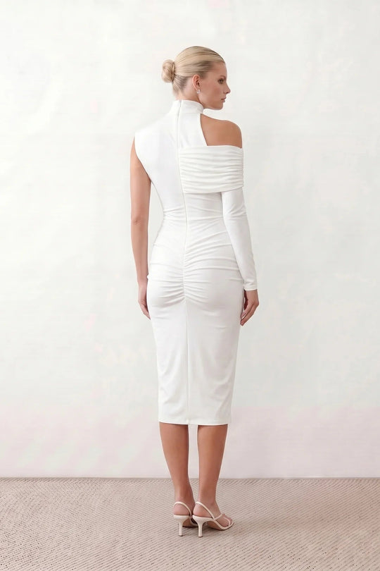 Woman wearing the Felisa Asymmetric Neck Open Back Midi Dress featuring an asymmetric mock-neck halter, off-shoulder ruched detailing, long fitted sleeves, an elegant open back, fitted midi silhouette and front slit, styled for weddings, cocktail parties and formal occasions.