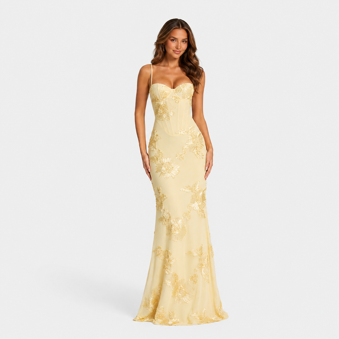 Women's floral embroidered corset maxi dress with delicate straps, fitted bodice, and flowing skirt for weddings and formal occasions.