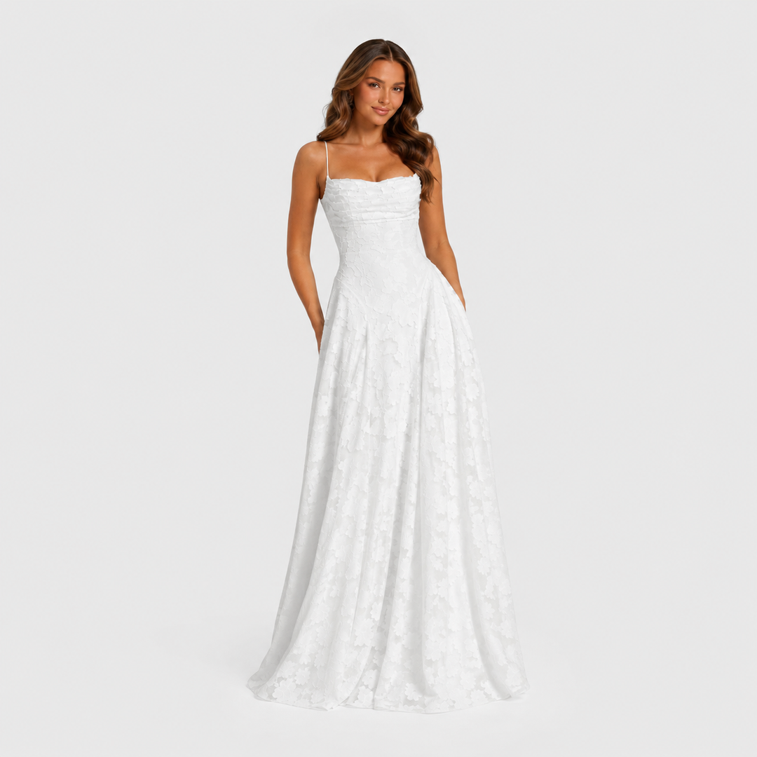 Women's textured floral maxi dress with fitted bodice, delicate shoulder straps, and flowing skirt for elegant wedding guest and formal occasion wear.