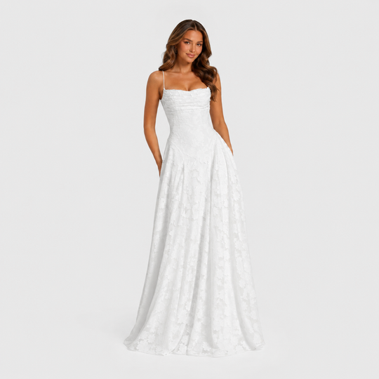 Women's textured floral maxi dress with fitted bodice, delicate shoulder straps, and flowing skirt for elegant wedding guest and formal occasion wear.