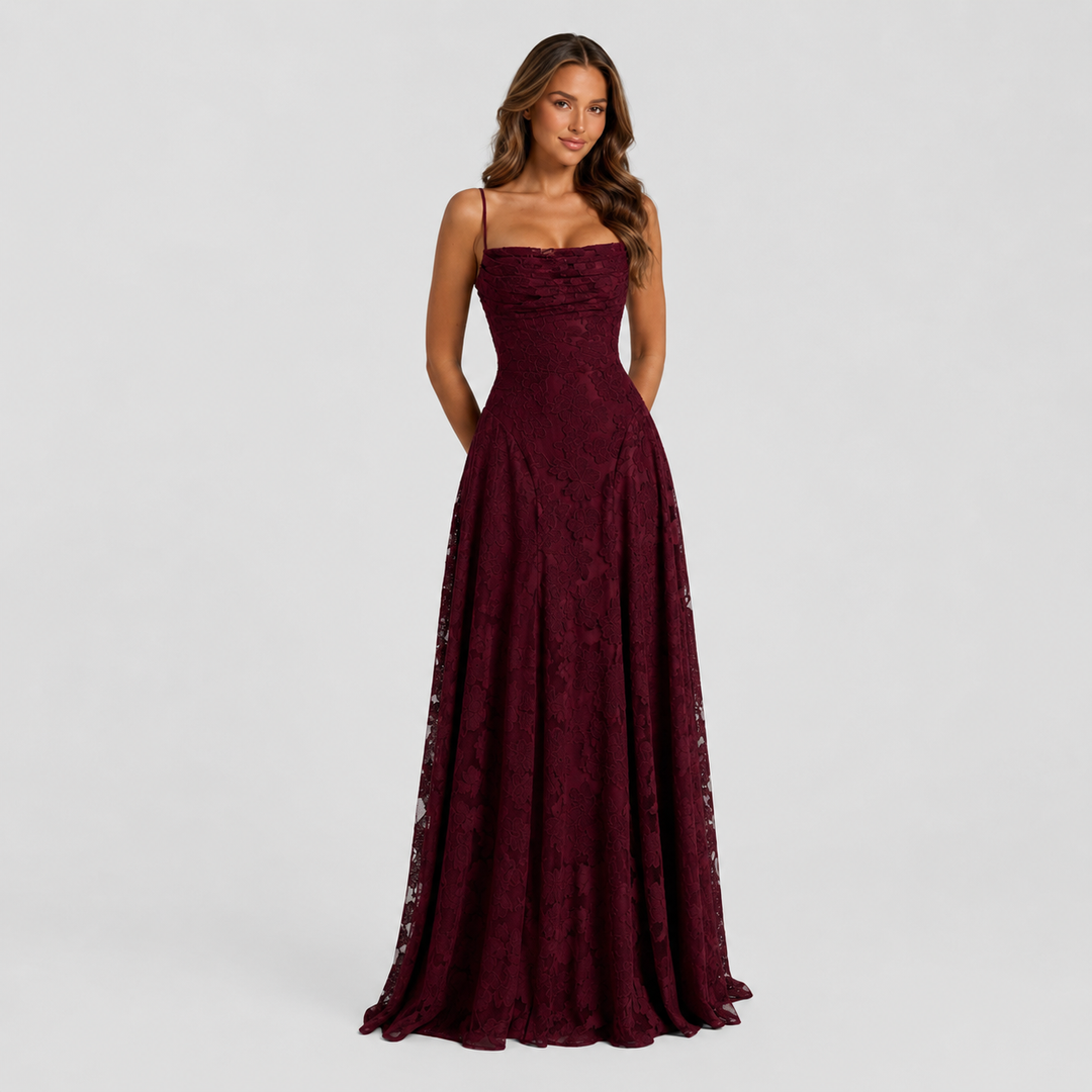 Women's textured floral maxi dress with fitted bodice, delicate shoulder straps, and flowing skirt for elegant wedding guest and formal occasion wear.