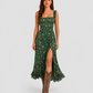 Woman wearing a boho floral maxi dress with a flowing silhouette, side slit detail, and lightweight fabric, styled for a relaxed summer occasion.
