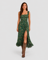Woman wearing a boho floral maxi dress with a flowing silhouette, side slit detail, and lightweight fabric, styled for a relaxed summer occasion.