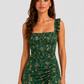 Woman wearing a boho floral maxi dress with a flowing silhouette, side slit detail, and lightweight fabric, styled for a relaxed summer occasion.