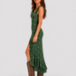 Woman wearing a boho floral maxi dress with a flowing silhouette, side slit detail, and lightweight fabric, styled for a relaxed summer occasion.