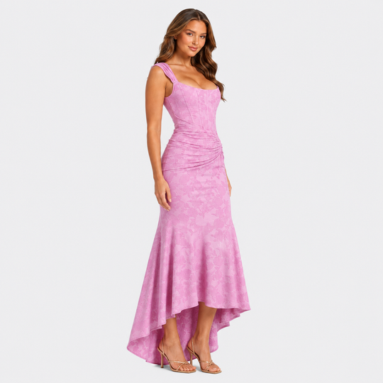 Women's floral textured corset maxi dress with ruched waist and asymmetrical fishtail hem in a feminine occasionwear silhouette.
