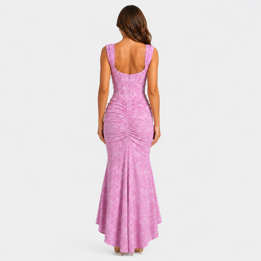 Women's floral textured corset maxi dress with ruched waist and asymmetrical fishtail hem in a feminine occasionwear silhouette.