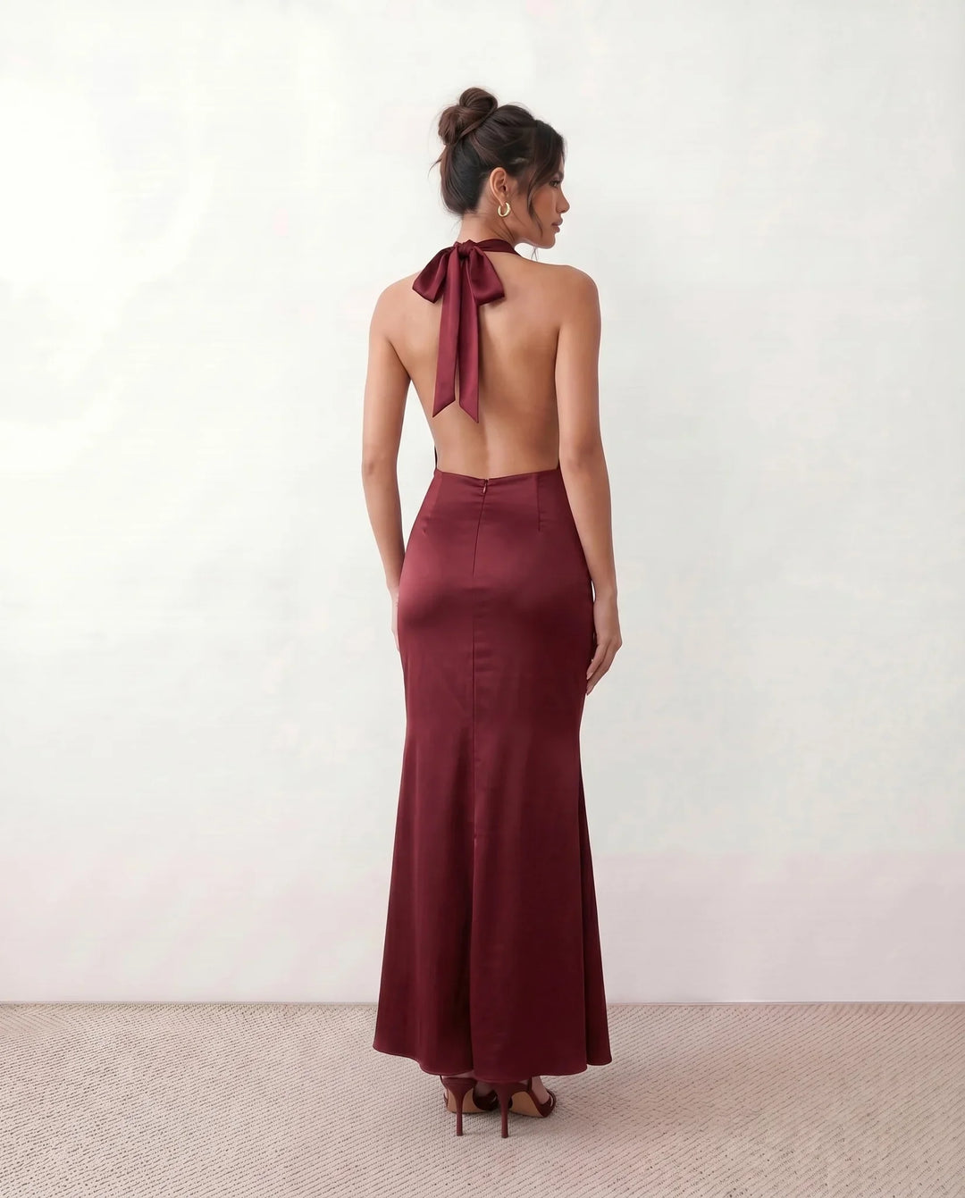 Shop the Women's Georgina Satin Cowl Neck Halter Maxi Dress. Featuring glossy satin, a draped halter neckline, open tie-back design, and a flattering mermaid silhouette, this elegant floor-length gown is perfect for weddings, black-tie events, proms, galas, and special occasions.
