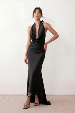 Shop the Women's Georgina Satin Cowl Neck Halter Maxi Dress. Featuring glossy satin, a draped halter neckline, open tie-back design, and a flattering mermaid silhouette, this elegant floor-length gown is perfect for weddings, black-tie events, proms, galas, and special occasions.