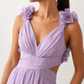 Woman wearing the Giedre Lace-Up A-Line Midi Dress featuring a deep V-neckline, ruffle shoulder sleeves, side waist cut-outs, adjustable lace-up open back and a flowing A-line midi skirt, ideal for weddings, race days and special occasions.