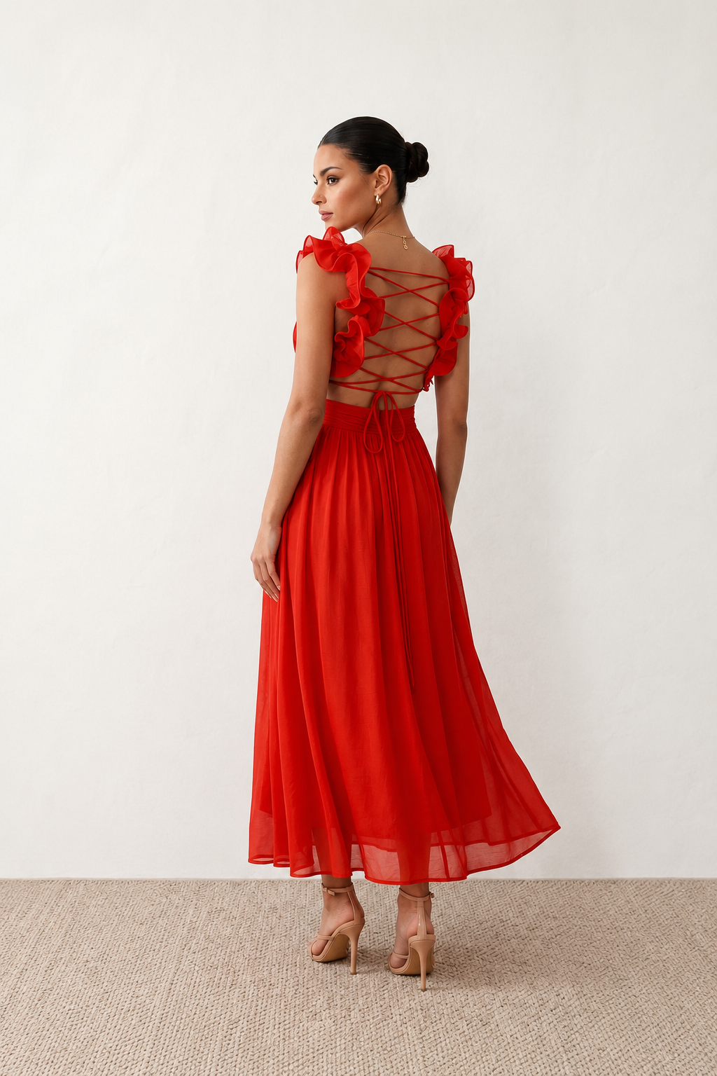 Woman wearing the Giedre Lace-Up A-Line Midi Dress featuring a deep V-neckline, ruffle shoulder sleeves, side waist cut-outs, adjustable lace-up open back and a flowing A-line midi skirt, ideal for weddings, race days and special occasions.