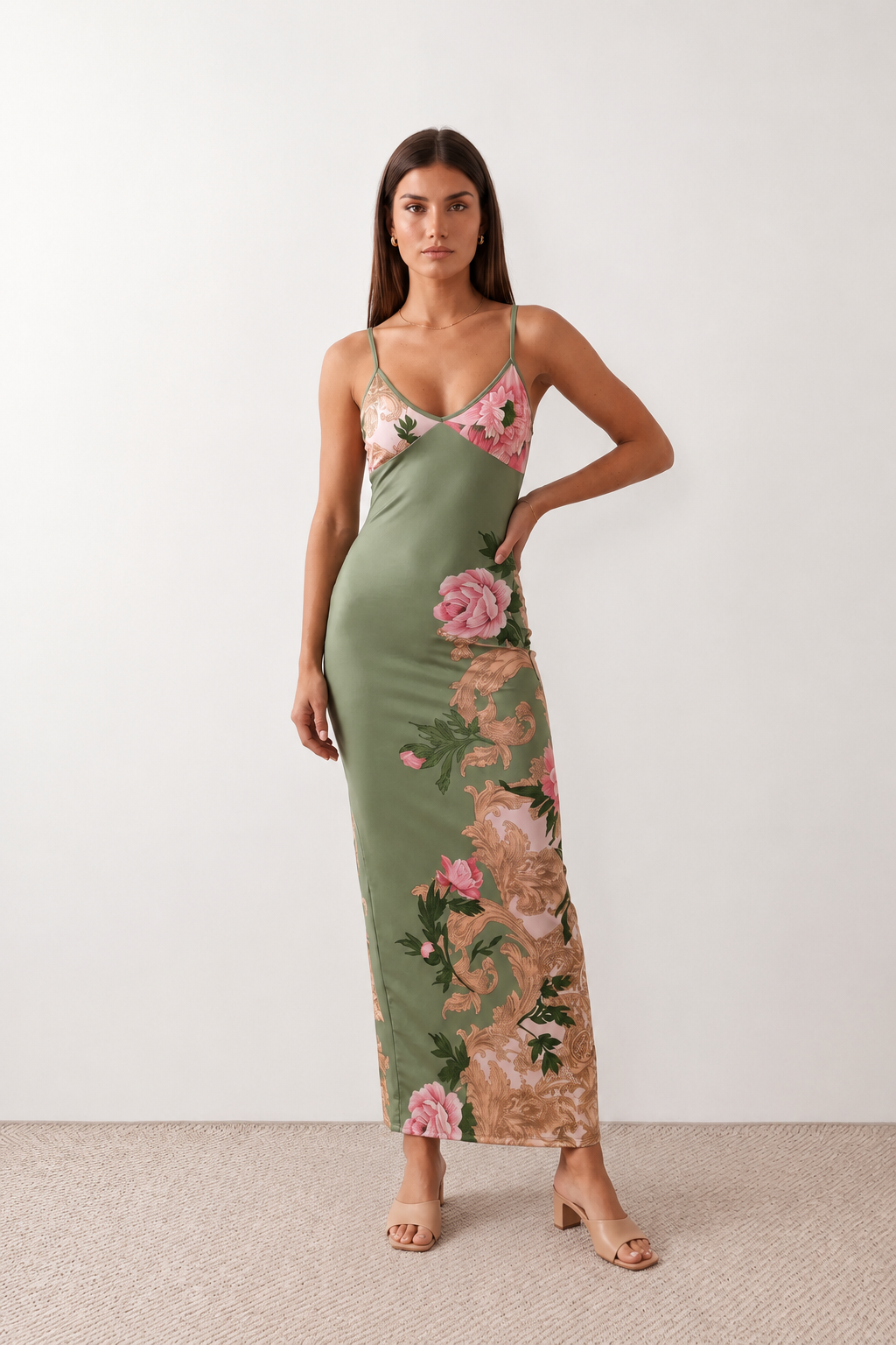 Woman wearing the Milota glossy floral slip maxi dress featuring a baroque-inspired floral print, deep V-neckline, adjustable spaghetti straps, low draped back, satin-look finish, and body-skimming floor-length silhouette, ideal for wedding guests and formal occasions.