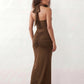 Woman wearing the Halter Neck Mermaid Maxi Dress featuring a sweetheart twist-knot neckline, sheer mesh waist panel, ruched mermaid silhouette, draped front skirt, open back with halter tie fastening, and elegant floor-length finish.