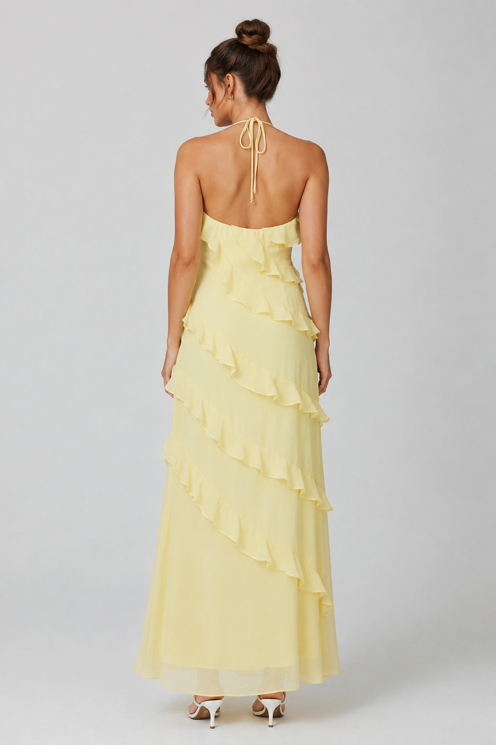 Women's halter neck ruffle maxi dress in a flowing full-length silhouette with soft ruffle detailing, lightweight fabric, and an elegant evening design.