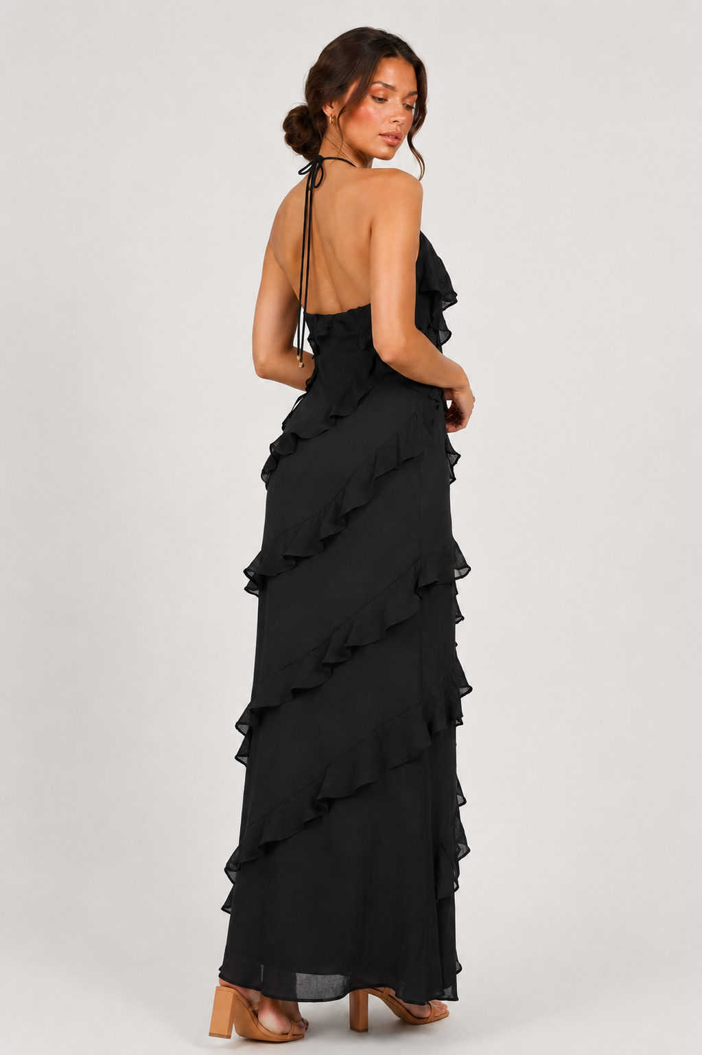 Women's halter neck ruffle maxi dress in a flowing full-length silhouette with soft ruffle detailing, lightweight fabric, and an elegant evening design.