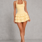 Women's halter ruffle mini dress featuring a corset-inspired fitted bodice, open back, layered ruffle skirt, and feminine flared silhouette, perfect for summer parties, wedding guests, and special occasions.