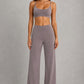 Women's high-waist straight-leg stretch trousers in smooth fabric with elastic waistband and side pockets, offering a flattering tailored fit and all-day comfort.