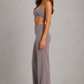 Women's high-waist straight-leg stretch trousers in smooth fabric with elastic waistband and side pockets, offering a flattering tailored fit and all-day comfort.