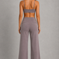Women's high-waist straight-leg stretch trousers in smooth fabric with elastic waistband and side pockets, offering a flattering tailored fit and all-day comfort.