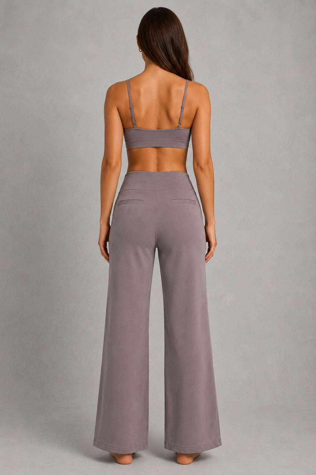 Women's high-waist straight-leg stretch trousers in smooth fabric with elastic waistband and side pockets, offering a flattering tailored fit and all-day comfort.