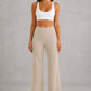 Women's high-waist straight-leg stretch trousers in smooth fabric with elastic waistband and side pockets, offering a flattering tailored fit and all-day comfort.