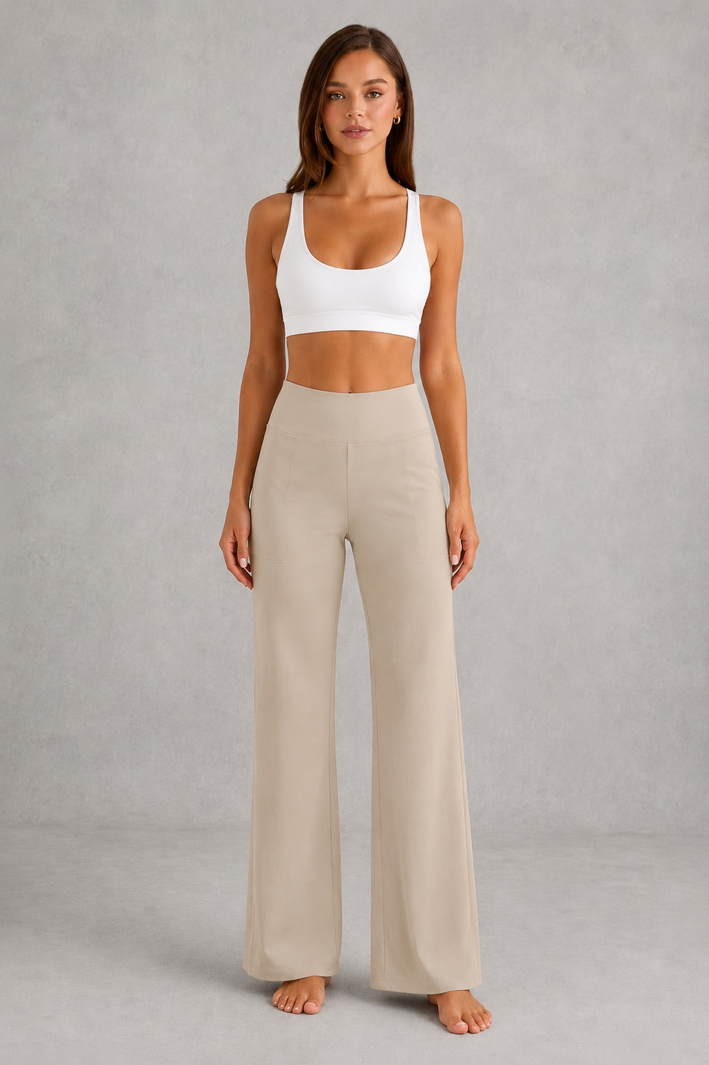 Women's high-waist straight-leg stretch trousers in smooth fabric with elastic waistband and side pockets, offering a flattering tailored fit and all-day comfort.