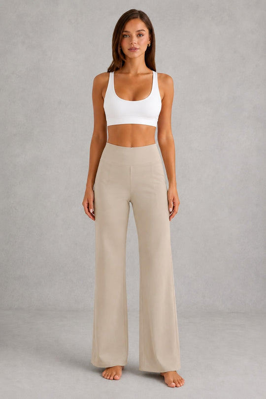 Women's high-waist straight-leg stretch trousers in smooth fabric with elastic waistband and side pockets, offering a flattering tailored fit and all-day comfort.