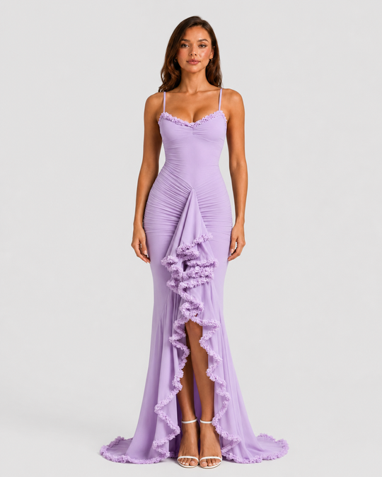 Woman wearing a spaghetti strap bodycon maxi dress with cascading ruffle detailing, high side split, and flowing hem for an elegant evening occasion look.
