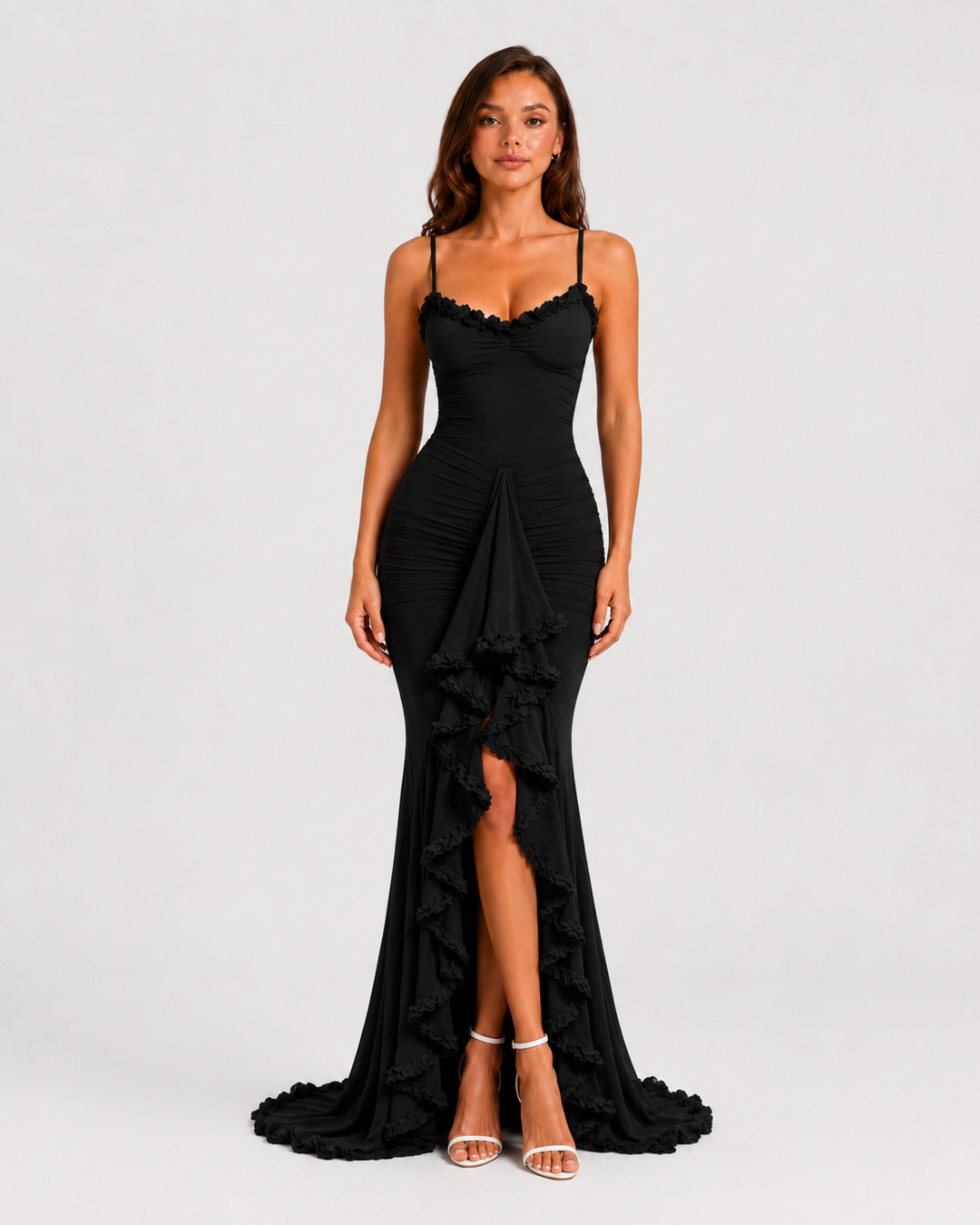 Woman wearing a spaghetti strap bodycon maxi dress with cascading ruffle detailing, high side split, and flowing hem for an elegant evening occasion look.