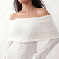 Woman wearing the Iustina Off Shoulder Fitted Maxi Dress featuring a Bardot neckline, soft draped shoulders, full-length sleeves, textured stretch knit fabric and a fitted floor-length silhouette, ideal for formal occasions and evening events.