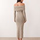 Woman wearing the Iustina Off Shoulder Fitted Maxi Dress featuring a Bardot neckline, soft draped shoulders, full-length sleeves, textured stretch knit fabric and a fitted floor-length silhouette, ideal for formal occasions and evening events.
