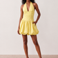 Woman wearing the Ivana Halter Plunge Neck Mini Dress featuring a halter V-neckline, ruched corset-style bodice, lace-up open back and ruffled mini hem, ideal for parties, cocktail events and special occasions.