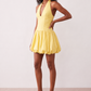 Woman wearing the Ivana Halter Plunge Neck Mini Dress featuring a halter V-neckline, ruched corset-style bodice, lace-up open back and ruffled mini hem, ideal for parties, cocktail events and special occasions.