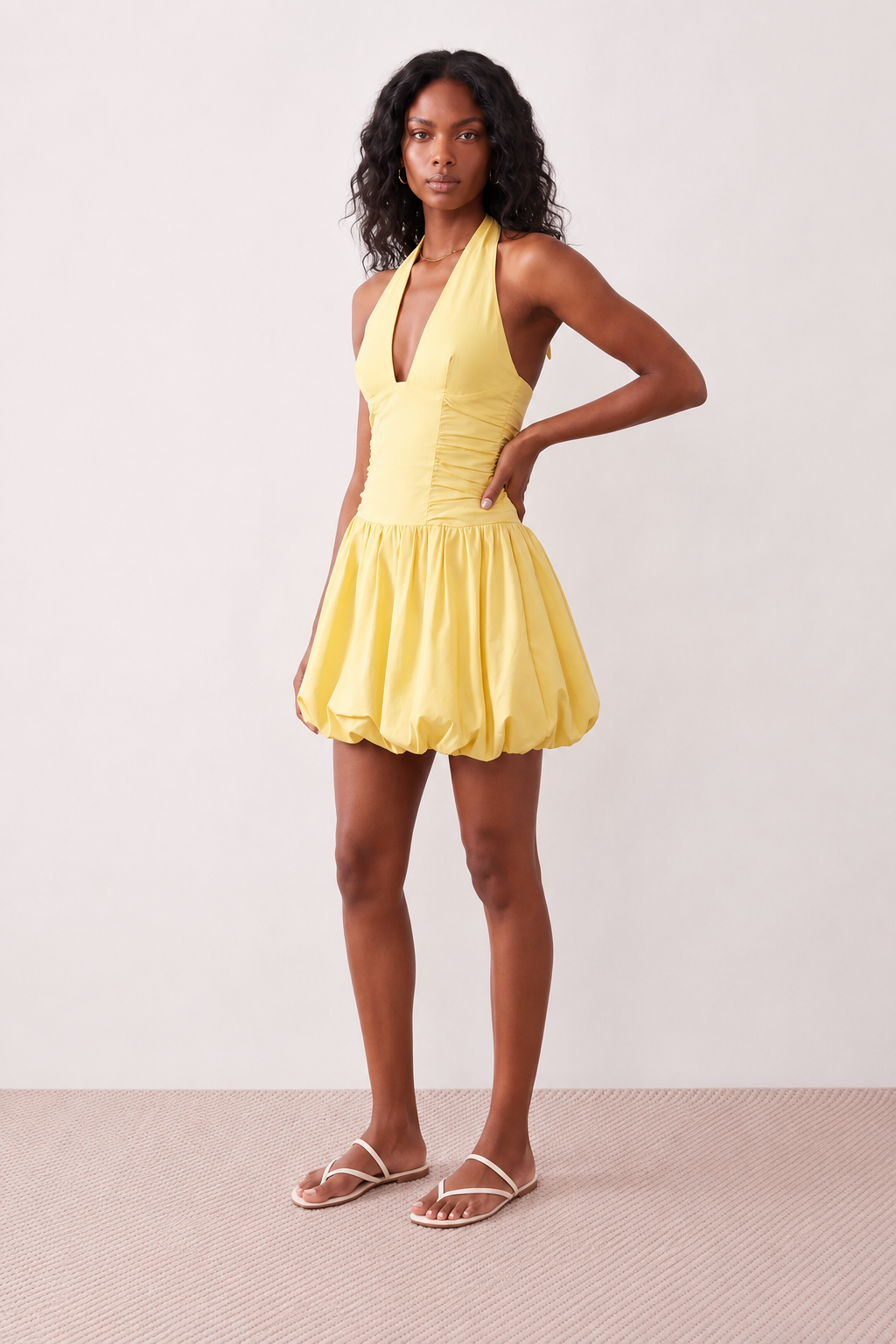 Woman wearing the Ivana Halter Plunge Neck Mini Dress featuring a halter V-neckline, ruched corset-style bodice, lace-up open back and ruffled mini hem, ideal for parties, cocktail events and special occasions.