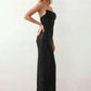 Woman wearing the Izabela sequined strapless maxi dress featuring shimmering all-over sequins, sparkling rhinestone embellishments, a ruched cowl-fold bust, adjustable lace-up corset back and a figure-skimming column silhouette with a floor-length hem, perfect for formal evening occasions.