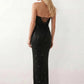 Woman wearing the Izabela sequined strapless maxi dress featuring shimmering all-over sequins, sparkling rhinestone embellishments, a ruched cowl-fold bust, adjustable lace-up corset back and a figure-skimming column silhouette with a floor-length hem, perfect for formal evening occasions.