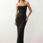 Woman wearing the Izabela sequined strapless maxi dress featuring shimmering all-over sequins, sparkling rhinestone embellishments, a ruched cowl-fold bust, adjustable lace-up corset back and a figure-skimming column silhouette with a floor-length hem, perfect for formal evening occasions.
