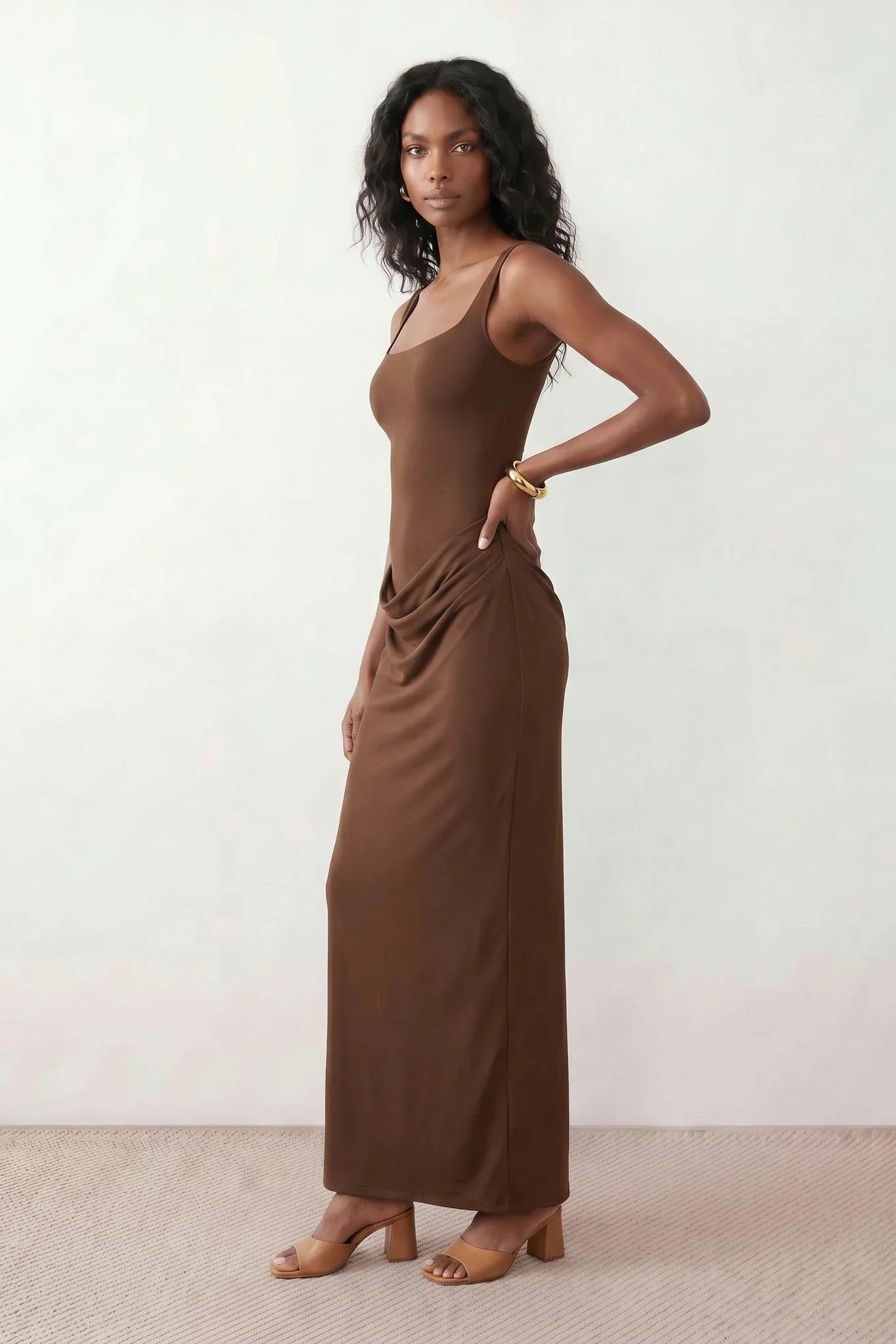 Women's Justina basque waist corset maxi dress featuring a structured boned bodice, square neckline, adjustable wide straps, ruched hip draping, side split, and a fitted floor-length silhouette for elegant evening and occasion wear.