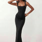 Women's Justina basque waist corset maxi dress featuring a structured boned bodice, square neckline, adjustable wide straps, ruched hip draping, side split, and a fitted floor-length silhouette for elegant evening and occasion wear.