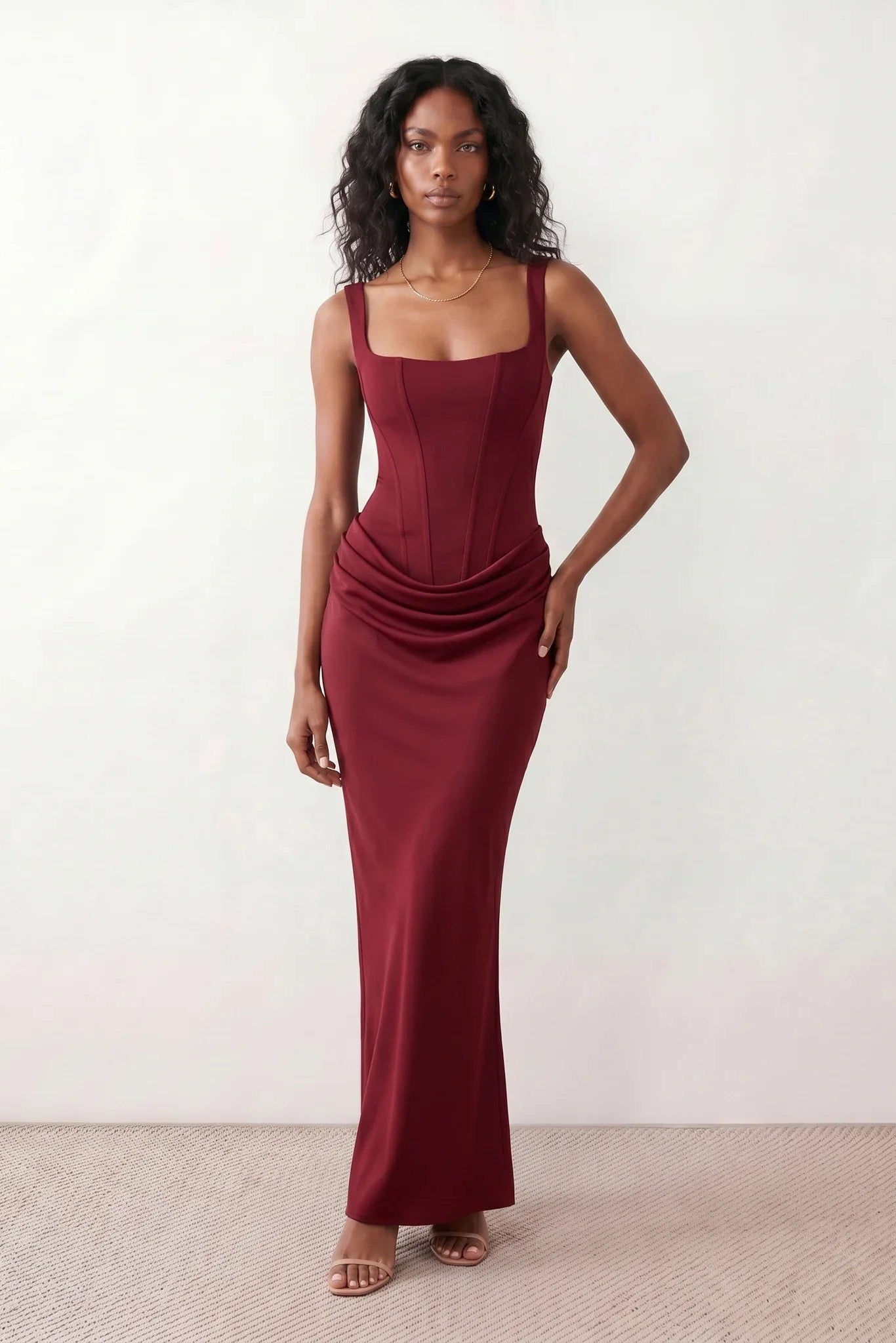 Women's Justina basque waist corset maxi dress featuring a structured boned bodice, square neckline, adjustable wide straps, ruched hip draping, side split, and a fitted floor-length silhouette for elegant evening and occasion wear.