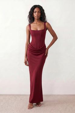 Women's Justina basque waist corset maxi dress featuring a structured boned bodice, square neckline, adjustable wide straps, ruched hip draping, side split, and a fitted floor-length silhouette for elegant evening and occasion wear.