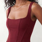 Women's Justina basque waist corset maxi dress featuring a structured boned bodice, square neckline, adjustable wide straps, ruched hip draping, side split, and a fitted floor-length silhouette for elegant evening and occasion wear.