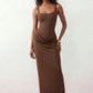 Women's Justina basque waist corset maxi dress featuring a structured boned bodice, square neckline, adjustable wide straps, ruched hip draping, side split, and a fitted floor-length silhouette for elegant evening and occasion wear.